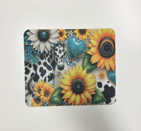 A custom sublimation acrylic jumbo paperclip featuring a design with sunflowers, a cow pattern, and a heart.