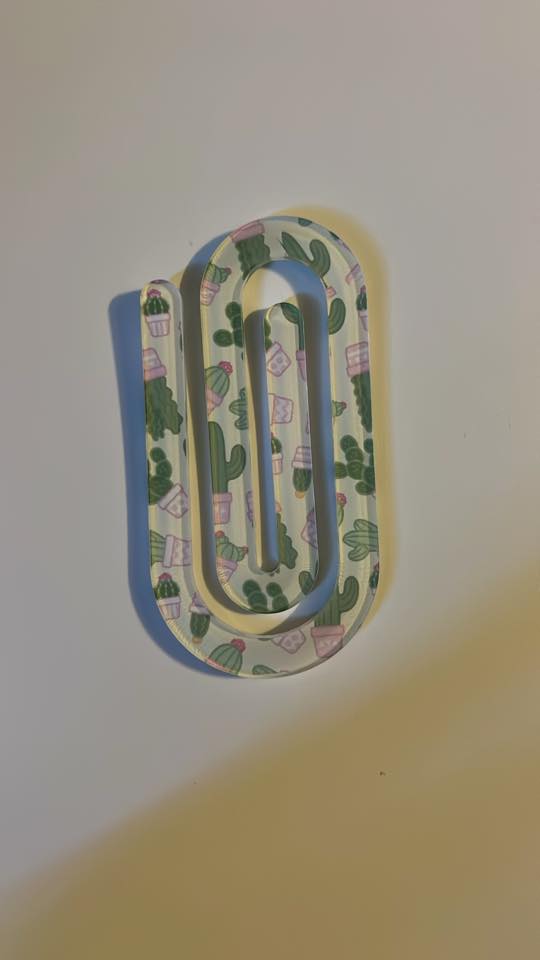 Decorative paper clip with a pattern on a plain background