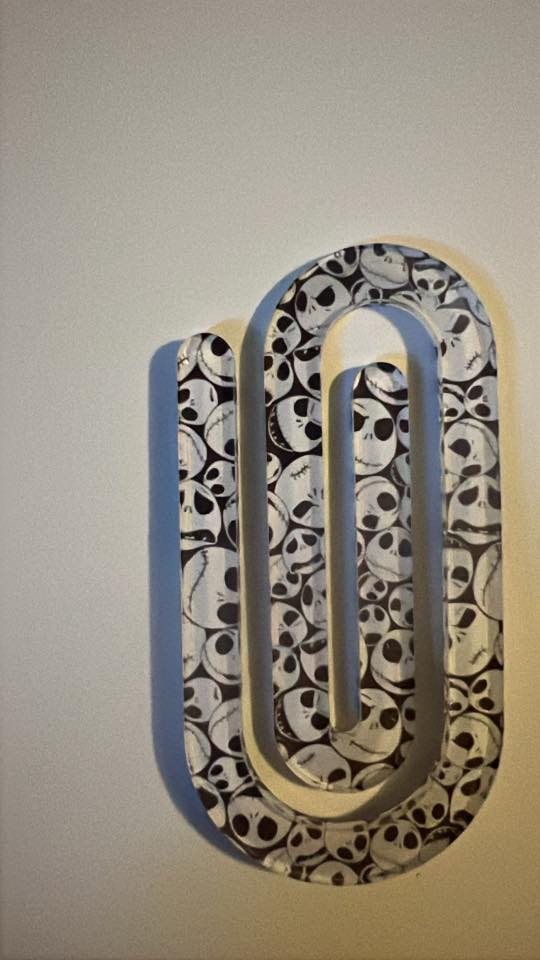 Decorative letter 'N' with skull pattern on a plain background