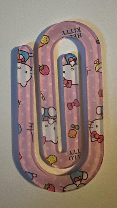 Pink paper clip with Hello Kitty design on a white background