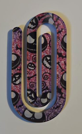 Decorative paper clip with a colorful pattern on a plain background