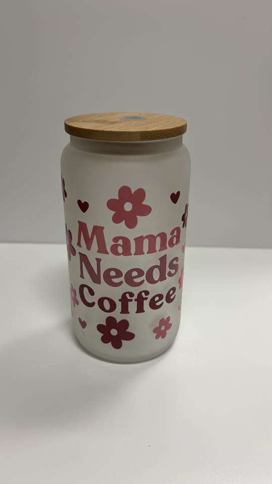 Jar with 'Mama Needs Coffee' text and floral designs on a white background