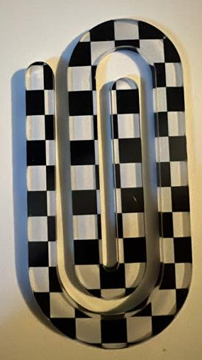 Decorative wall art with black and white checkered pattern on a plain background