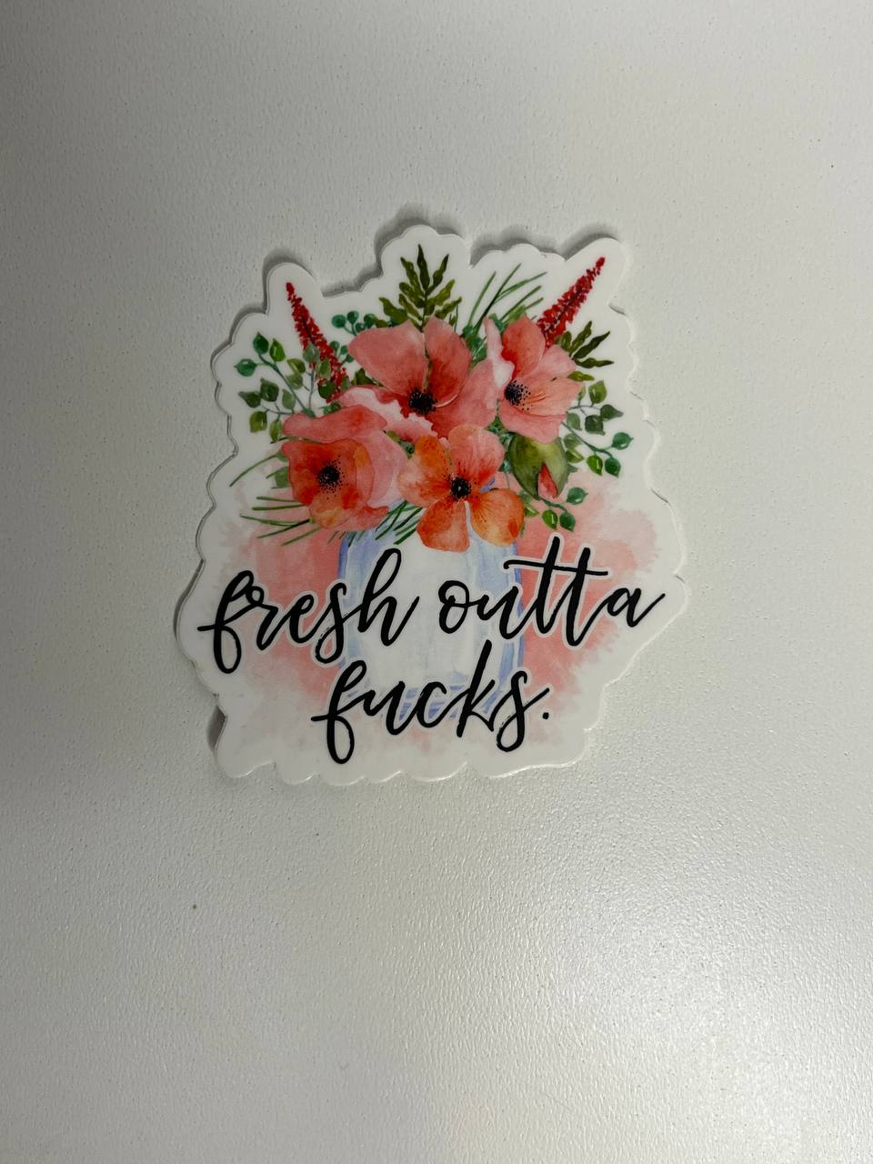 Sticker with floral design and text on a plain background