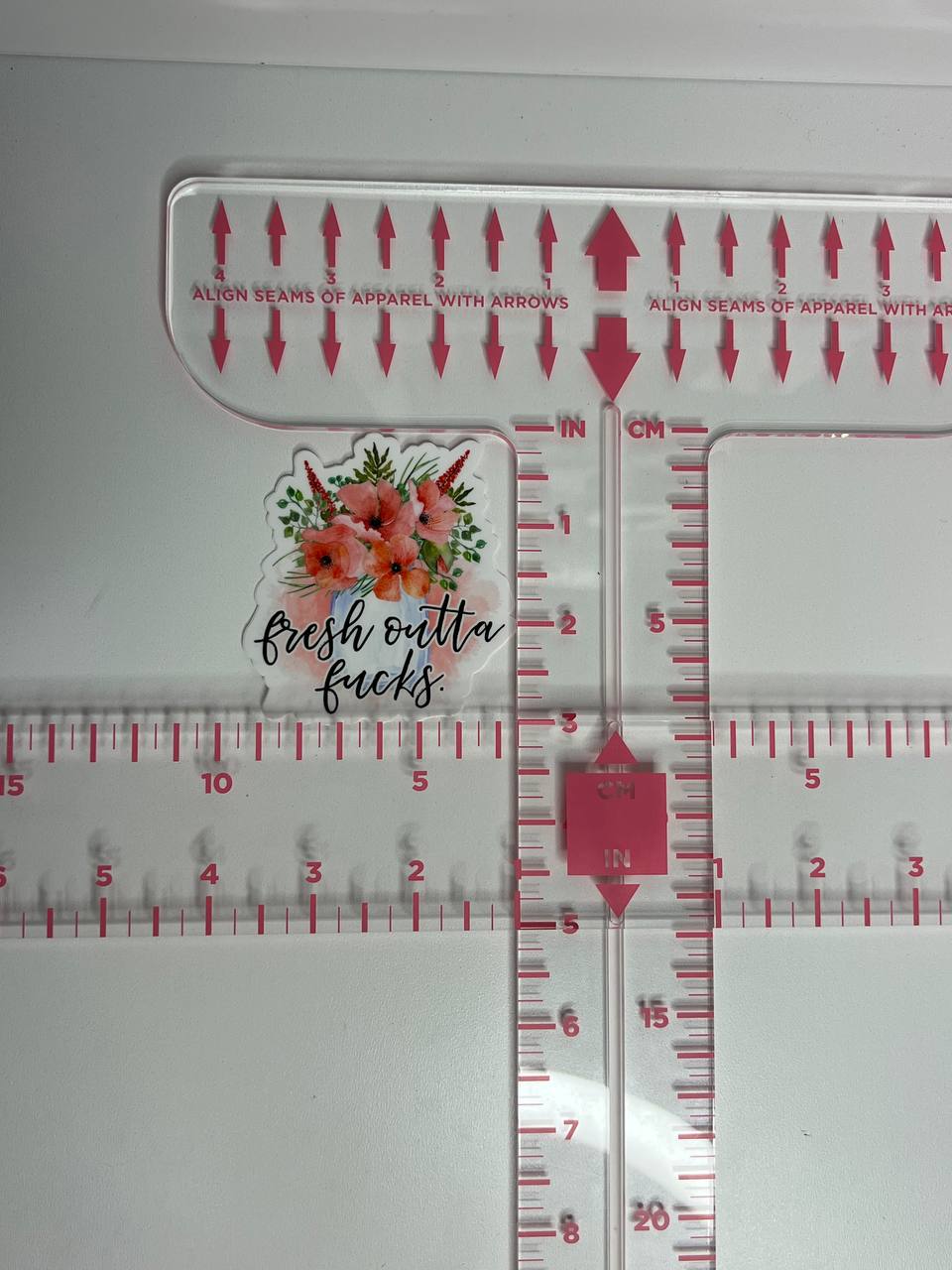 Measurement tool with floral design and text on a white background