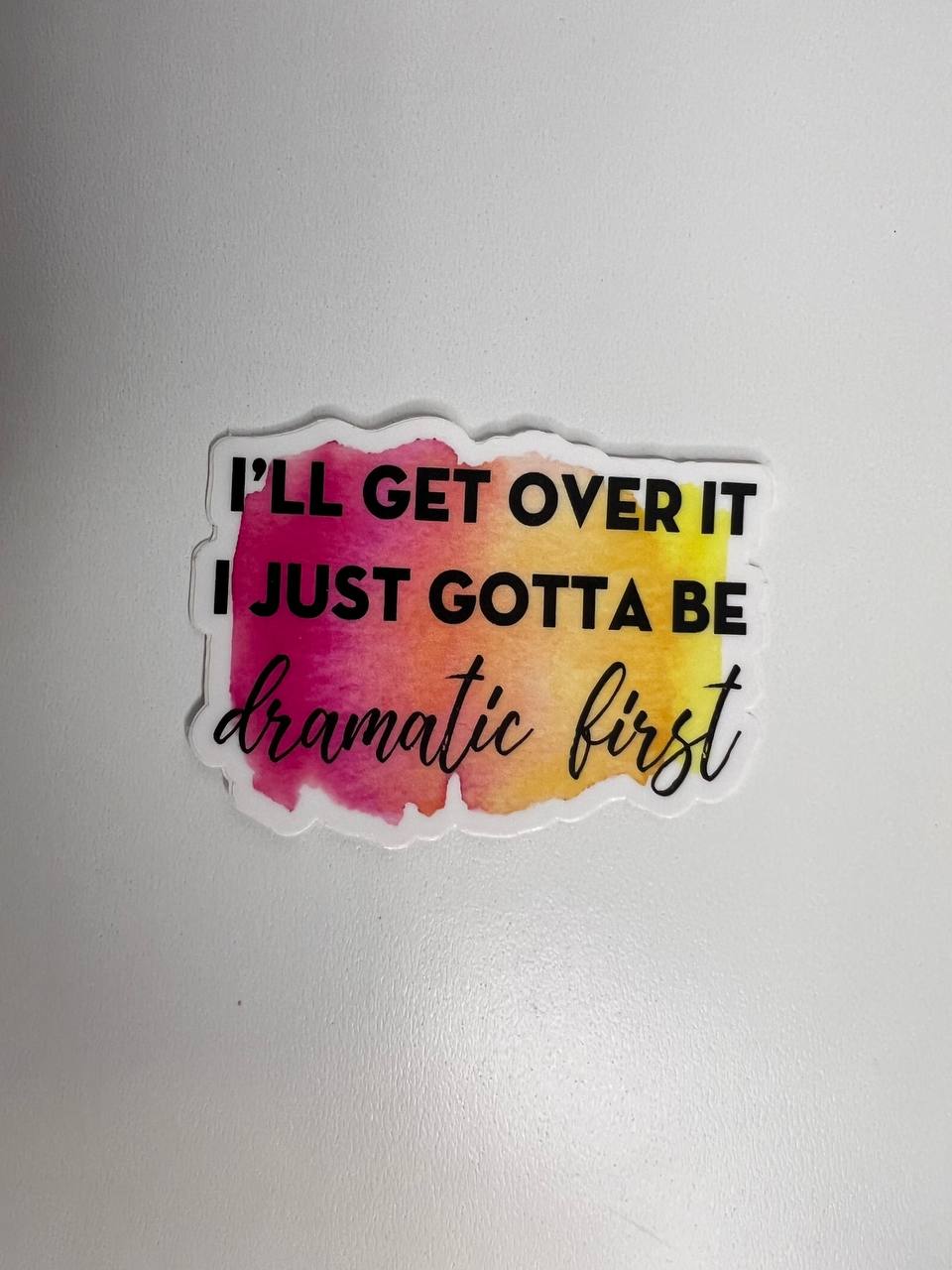 Sticker with colorful watercolor design and text on a plain background