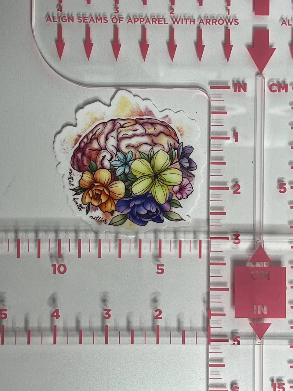 Floral brain sticker on a ruler for size reference