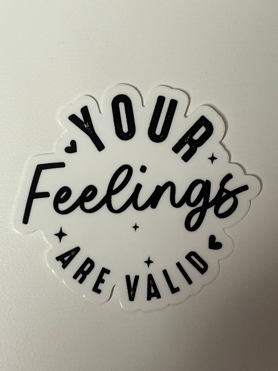 Sticker with 'Your Feelings Are Valid' text on a light gray background