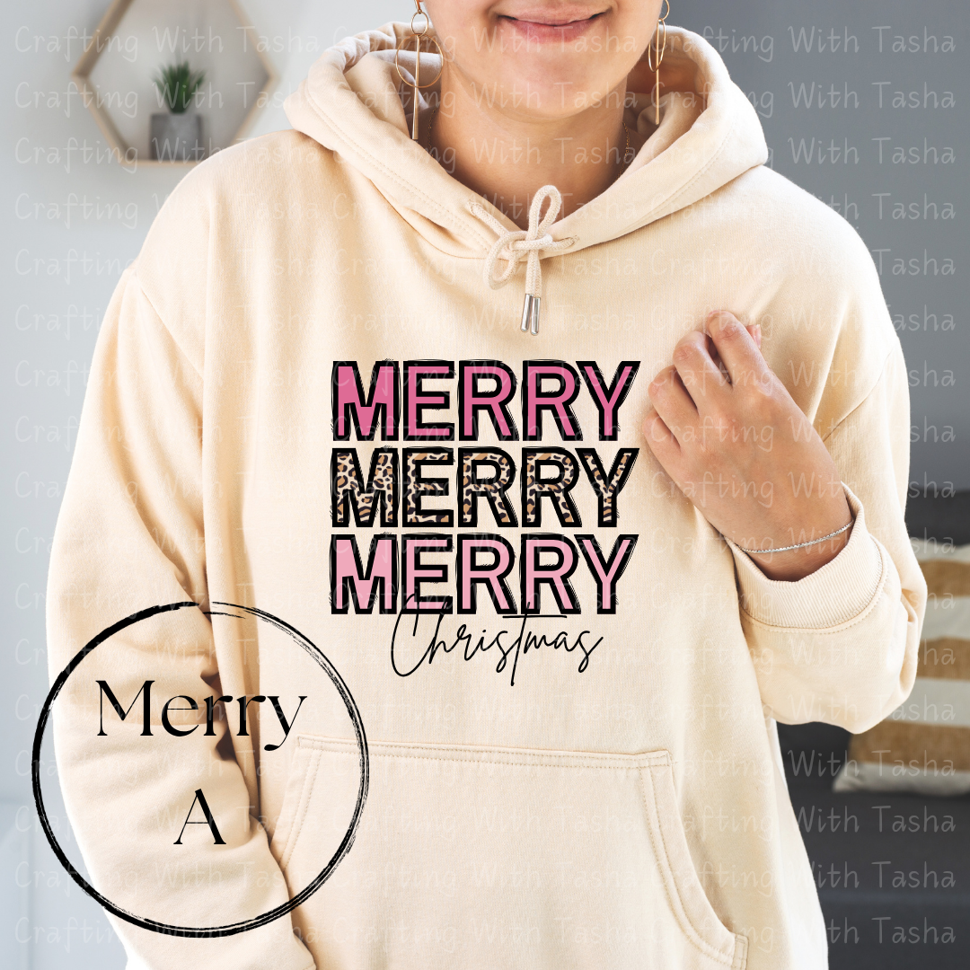 Beige hoodie with 'Merry Merry Merry Christmas' text, worn by a person.